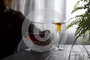 Silhouette of anonymous alcoholic woman person drinking behind glass of alcohol. Alcohol addiction and Social problem -