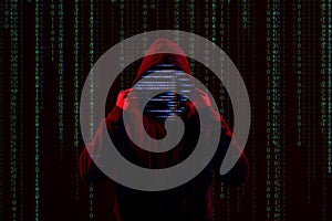 Silhouette of anonymous hacker and digital binary code. Cyber attack concept