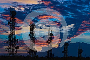 Silhouette of the Antenna of cellular cell phone and communication system tower arranged as a bar chart on cloud and blue sky