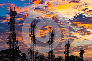 Silhouette of the Antenna of cellular cell phone and communication system tower arranged as a bar chart on cloud and blue sky