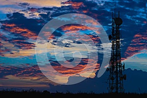 Silhouette of the Antenna of cellular cell phone and communication system tower on cloud and blue sky