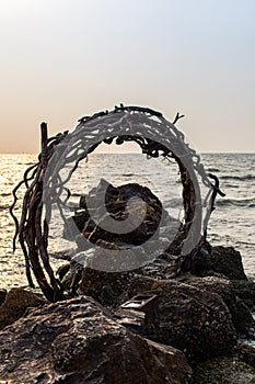 Silhouette of arch against sunset in he sea