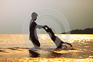 Silhouette of asian father carrying his daughter turn around