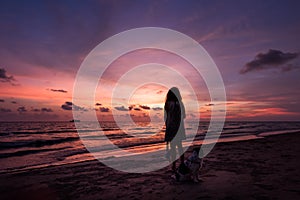 Silhouette of Asian girl on the beach on sunset