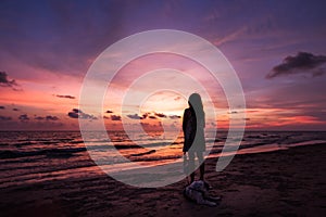 Silhouette of Asian girl on the beach on sunset