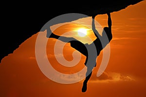 Silhouette of asian man climbing rock