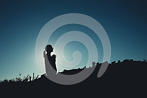 Silhouette of Asian woman is pray on mountain