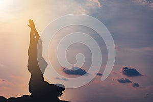 silhouette Athletic woman practice yoga lotus pose to meditation summer vacation on pier with sunset sea beach