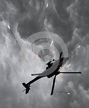 Silhouette of an attack helicopter firing flares