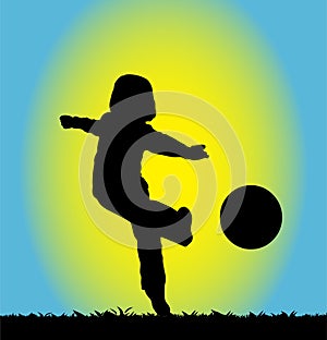 Silhouette of a b oy playing football