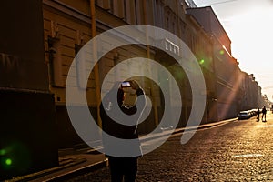 Silhouette of back view young man using smartphone taking a picture the icon of landmark at Eiffel tower in Paris,France with