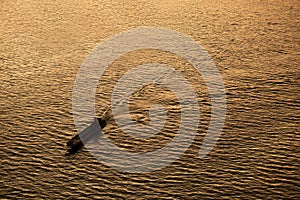 Silhouette Background of a boat is running through a river in th