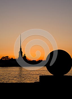 Silhouette of a ball and Peter and Paul Fortress in sunrise