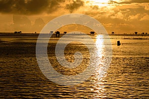 Silhouette of bamboo cottage with morning sunshine in gulf of Thailand