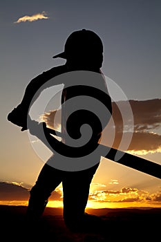 Silhouette baseball swing beginning sunset