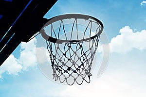 Silhouette basketball hoop outdoors in the cloud and blue sky