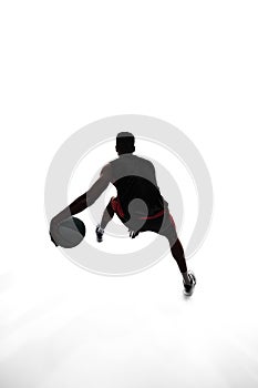 Silhouette of basketball player in motion with ball, make athlete playing isolated on white background