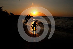 Silhouette on the beach at sunset