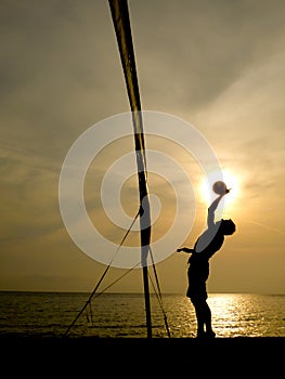 Silhouette of beach volleyball player