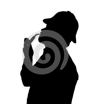 Silhouette of bearded man smoking pipe with Sherlock hat looking