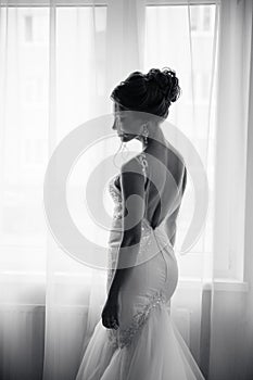 Silhouette of a beautiful bride in a traditional white wedding dress