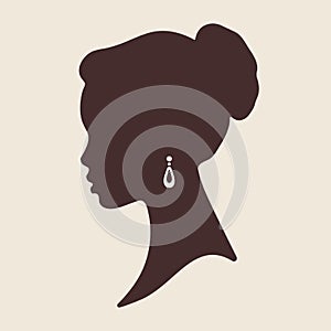 Silhouette of beautiful elegant african woman in profile isolated vector illustration. Beauty salon or jewelry product logo design