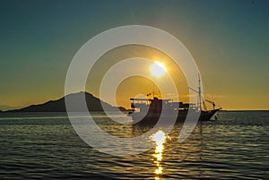 Silhouette of beautiful sunset with fishing boat. Beautiful Sunset in tropical Komodo island, Labuan Bajo, Fores, Indonesia