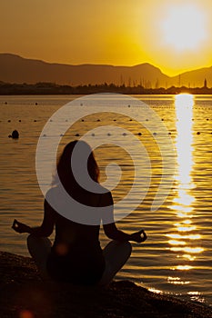 Silhouette of a beautiful woman excercising Yoga