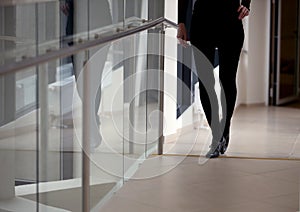 Silhouette of a beautiful woman`s legs, black pants, black shoes, office