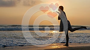 silhouette of beautiful woman standing on beach near sea wave. Love postcard concept. Happy valentines day