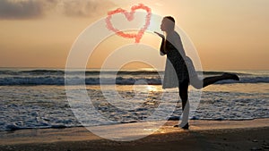 silhouette of beautiful woman standing on beach near sea wave. Love postcard concept. Happy valentines day