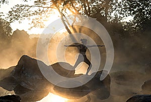 Silhouette of a beautiful Yoga woman in the morning