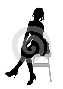 Silhouette of a beautiful young slender girl with long wavy  hair, who sits on a bar stool and holds her arms crossed in her lap