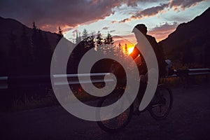 Silhouette of a bicyclist at sunset in the mountain