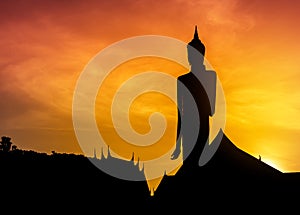 Silhouette big buddha statue standing in thai temple on sunset