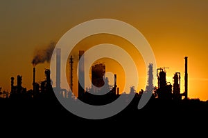 Silhouette of big oil refinery factory during sunset