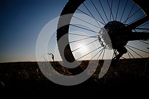 Silhouette of the bike against the blue sky at sunset