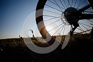 Silhouette of the bike against the blue sky at sunset