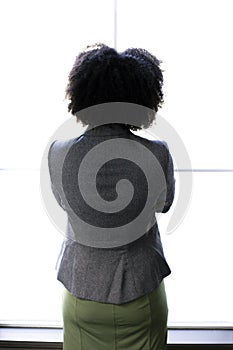 Silhouette of a Black Businesswoman Worried Next to an Office Window
