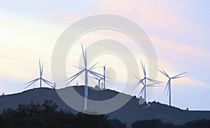 Wind turbines running at sunset in La Puebla de GuzmÃÂ¡n, Huelva, Andalusia, Spain.