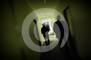 Silhouette Motion Blur Men In Dark Corridor photo