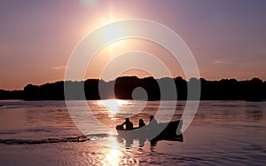 The silhouette of a boat navigating the Danube river.