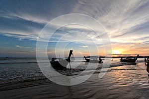 Silhouette of boat and people against the sunset sky