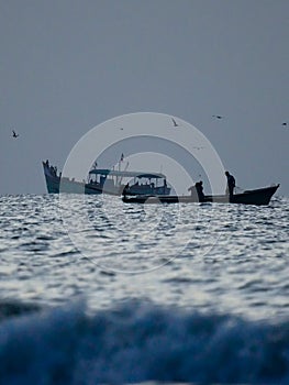 silhouette of boat in the sea, early morning fishing