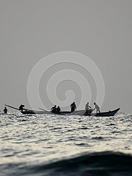 silhouette of boat in the sea, early morning fishing