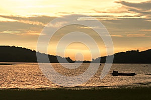 Silhouette of a boat in the water and the evening