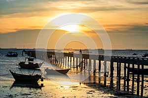 Silhouette boats and bridge at sunset, Bang Phra beach, Chonburi