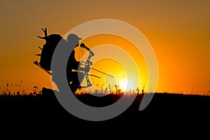 Silhouette of a bow hunter photo