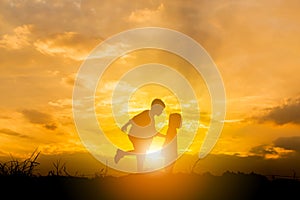 Silhouette of Boy and girl playing at sunset background, Happy children concept