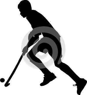 Silhouette of boy hockey player running with ball